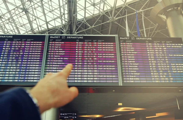 Flights information board in airport terminal — Stock Photo, Image