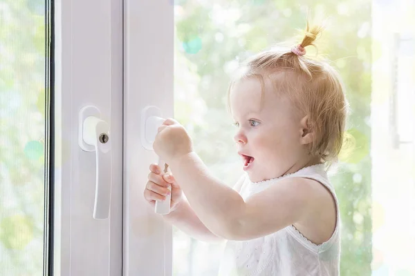 Child window with lock close up. Child at window macro. Window with lock