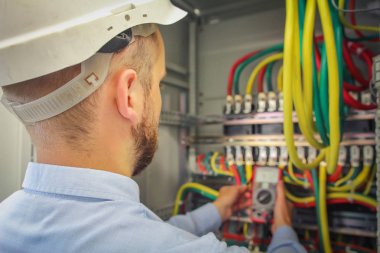 Elektrik mühendisi yüksek güçlü elektrik devrelerinin multimetre gerilim ölçer.