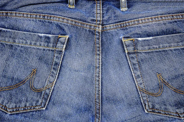 Jeans broek met zakken. Denim stof close-up. Jeans achtergrondstructuur. — Stockfoto