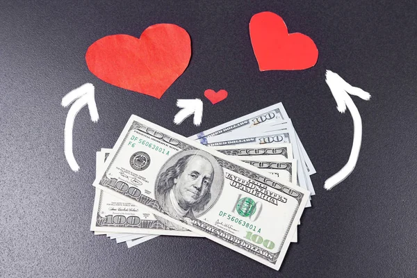 Love for money concept. topic of prostitution. Dollars and red hearts on black background are connected by arrows. Selling love. Sex for money.