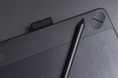 modern black graphic tablet for drawing with pen close-up. clipart