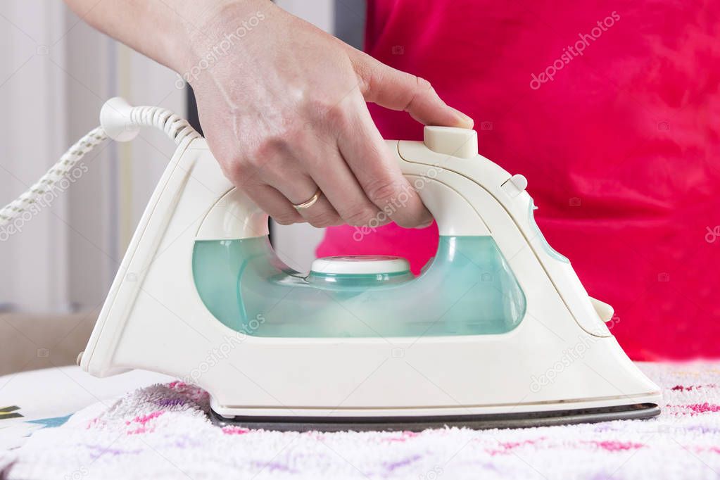 woman ironing clothes at home.