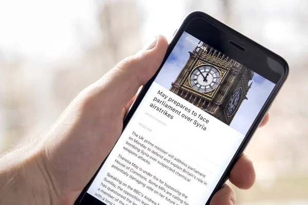 Minsk, Beyaz Rusya - 14 Nisan 2018: Makale Suriye haber euronews kanal uygulamada el adam akıllı telefon ekranında.