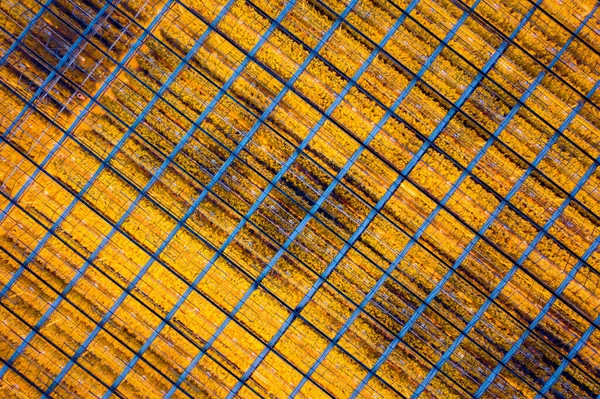 Illuminated greenhouse aerial view. Yellow lights in greenhouse