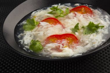 Clear egg soup with tomatoes clipart