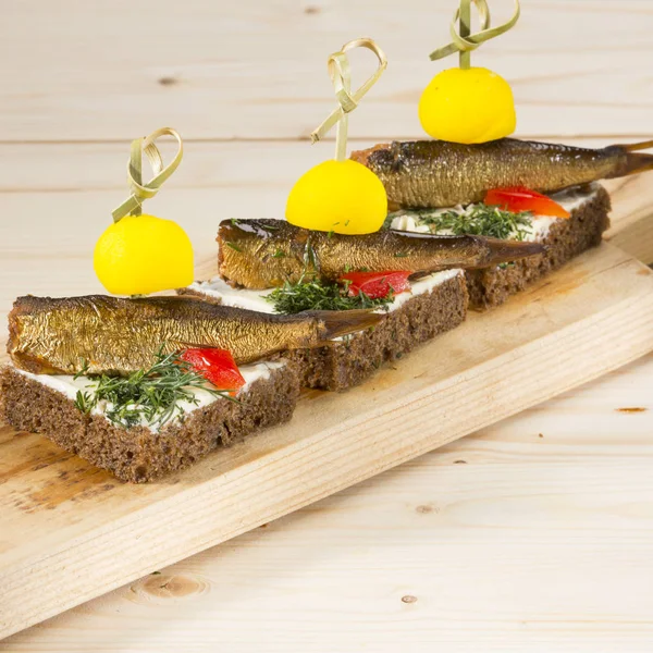 Sprat canape with butter and brown bread — Stock Photo, Image