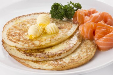 Pancakes with salmon and butter clipart