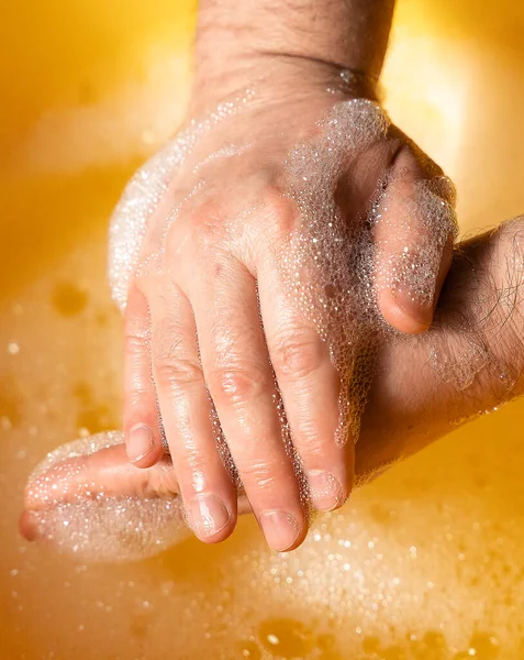 hand washing in water with soap suds