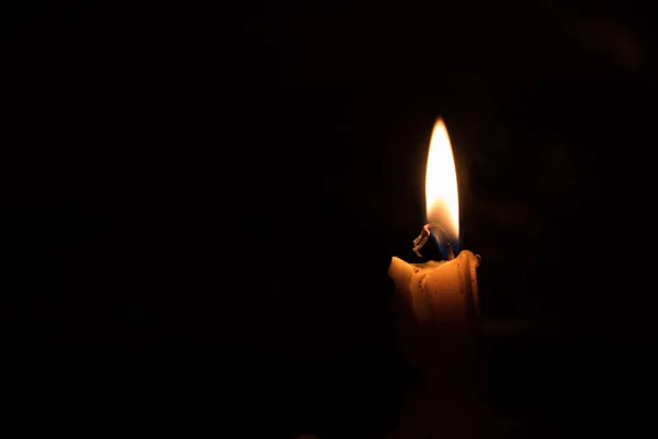 One light candle burning brightly, image is isolated against a b — Stock Photo, Image