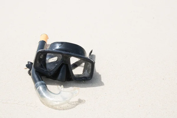 Diving mask and snorkel on sand at phuket thailand beach.