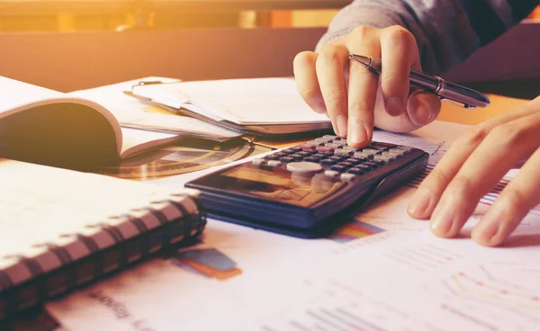 Wanita menggunakan kalkulator dengan melakukan keuangan di kantor pusat. — Stok Foto