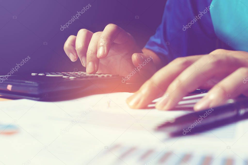 Young asian woman doing finance with calculate about cost at hom