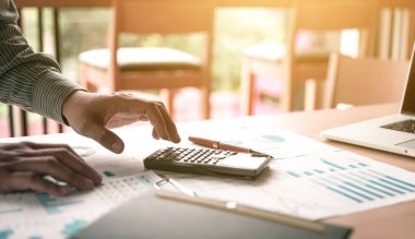 Ayakta ve hesap makinesi hakkında özet raporu o kullanarak iş adamı