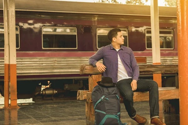 Yalnız adam bekleyen tren tren istasyonunda.