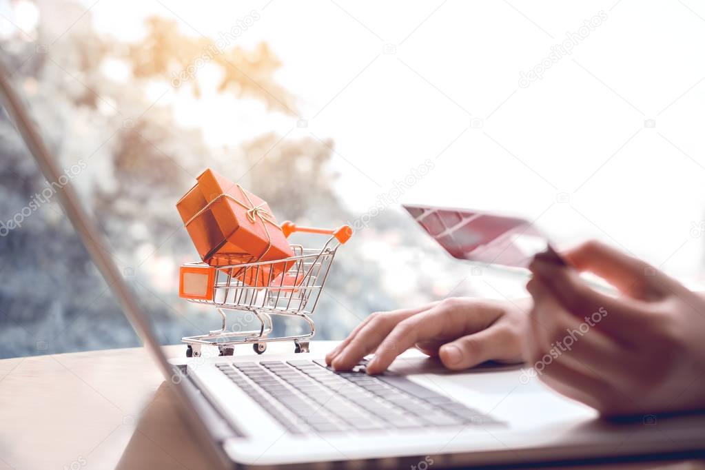 Online shopping concept with woman hand using laptop and looking
