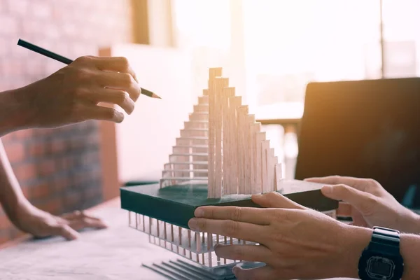 Designers or architect reviewing architectural model in the offi