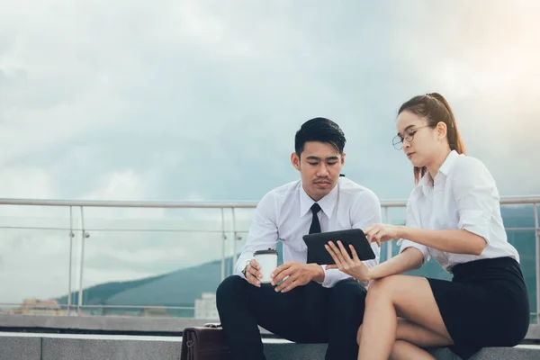 Two business couple using digital tablet working together. — Stock Photo, Image