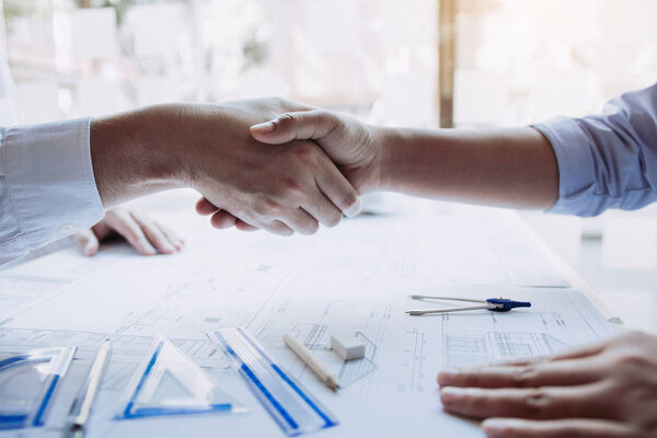 Two engineering man with construction worker greeting a foreman 