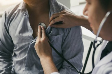 Asyalı doktor stetoskop dinle t kalp atışı için kullanıyor