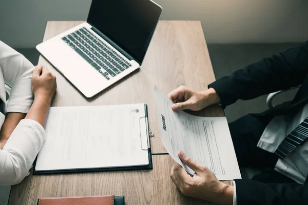 Job applicants are holding a resume document in the job interview room, job interview concept.