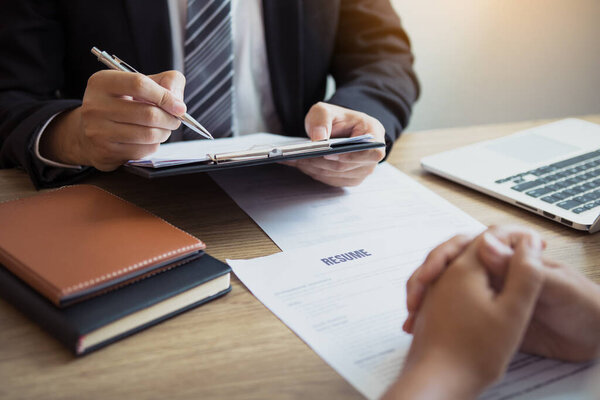 Smart businessman professional man in suit executive gesturing and talking in meeting with interview employee women about work in modern office.