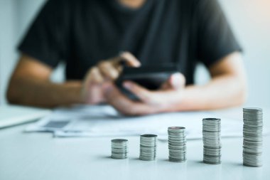 Paralar tasarruf fikri ile düzenlenmiş iken Asya Erkekler evde maliyet veya gelecekteki yatırım hakkında mali hesaplanıyor.