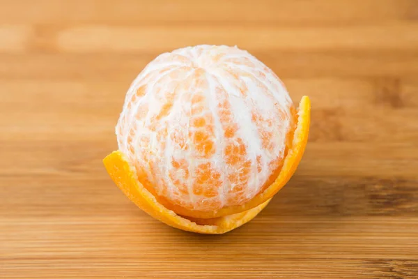 One navel orange peeled