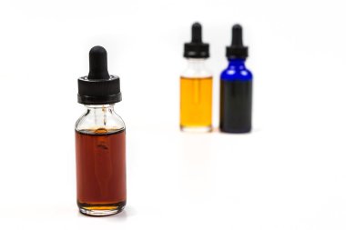 Flavored vape juice with shallow depth of field and objects out of focus clipart