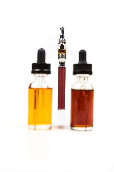Assorted flavors of vape juice and an ecigarette — Stock Photo, Image
