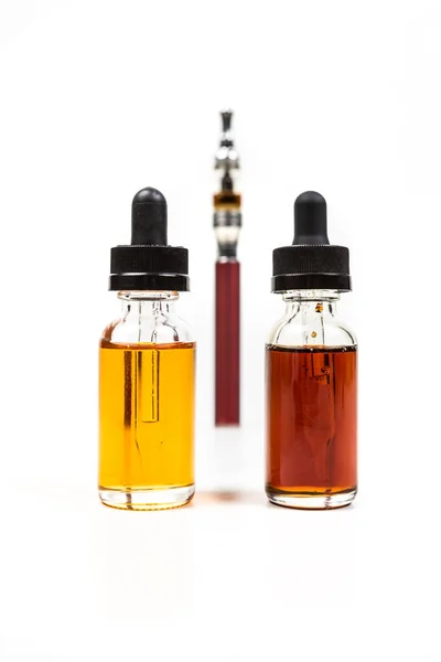 Assorted flavors of vape juice and an ecigarette — Stock Photo, Image