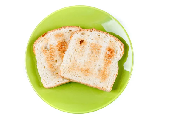 Két szelet teljes kiőrlésű kenyér pirított a kerámia tányér — Stock Fotó