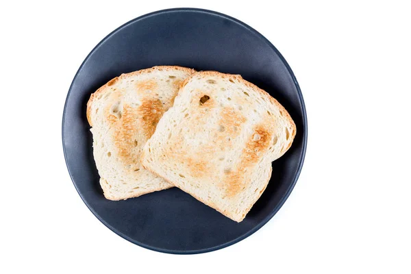 Dos rebanadas enteras de pan tostado en un plato de cerámica —  Fotos de Stock