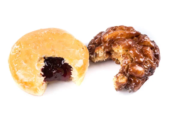 Donuts parcialmente comidos con un bocado sacado — Foto de Stock