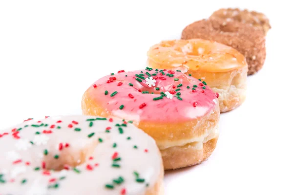 Frosted Donut Lineup flache Schärfentiefe — Stockfoto