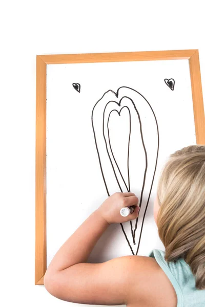 Young girl drawing on a dry erase board