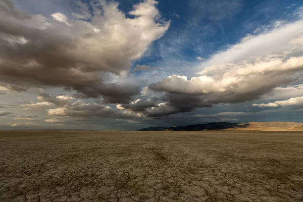 Grandes nuvens inchadas sobre um deserto árido — Fotografia de Stock