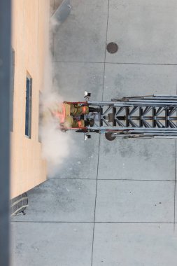 Firefighter training entering and exiting a building clipart