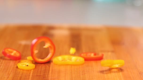 Red Yellow Orange Pepper Slices Dropped Cutting Board Slow Motion — Stock Video