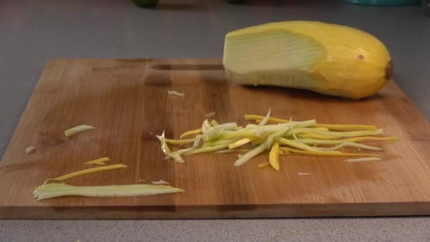 Dropping Julienned Slices Yellow Summer Squash Wood Cutting Board — Stockvideo