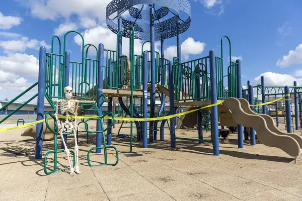 Adult Skeleton Sitting Playground Equipment Empty Closed Park Nice Day — Stock Photo, Image