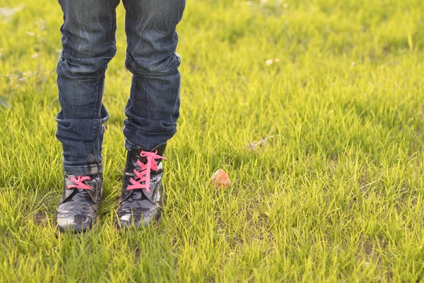 Childrens legs and feet in stylish fashionable childrens shoes. Vegetarian Vegan and recycled materials fashion. Alternative fashion, shoes made from plant materials. Copy space.