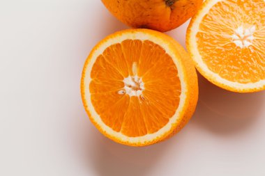 dilimlenmiş portakal yarısı ve bütün beyaz arka plan portre üzerinde