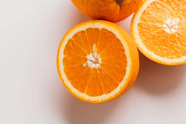 dilimlenmiş portakal yarısı ve bütün beyaz arka plan portre üzerinde