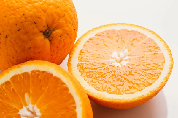 dilimlenmiş portakal yarısı ve bütün beyaz arka plan portre üzerinde