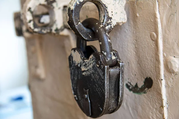 a padded massive lock hangs on the door