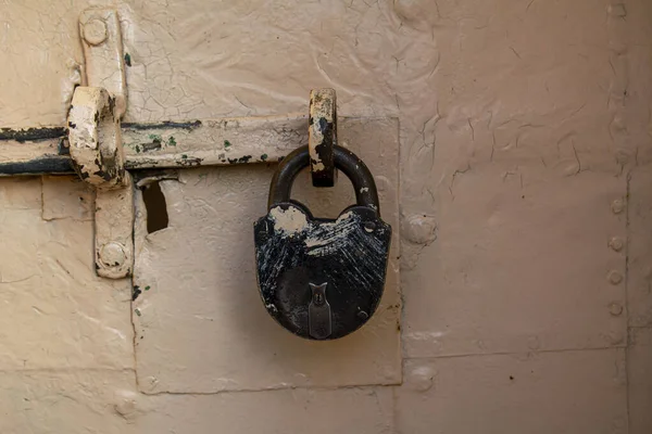 a padded massive lock hangs on the door