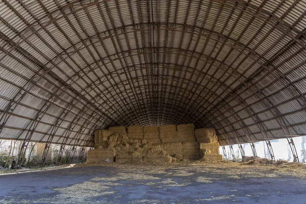 Large hangar for storing straw or hay. Cover for storage. Dry hay in the barn. — Stock Image Large Hangar Storing Straw Hay Cover Storage Dry Hay Barn Stock Photo