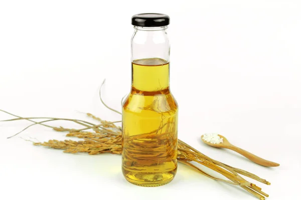 Rice bran oil in bottle glass and rice — Stock Photo, Image