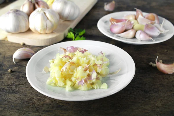 Garlic with leaves of coriander isolated on white